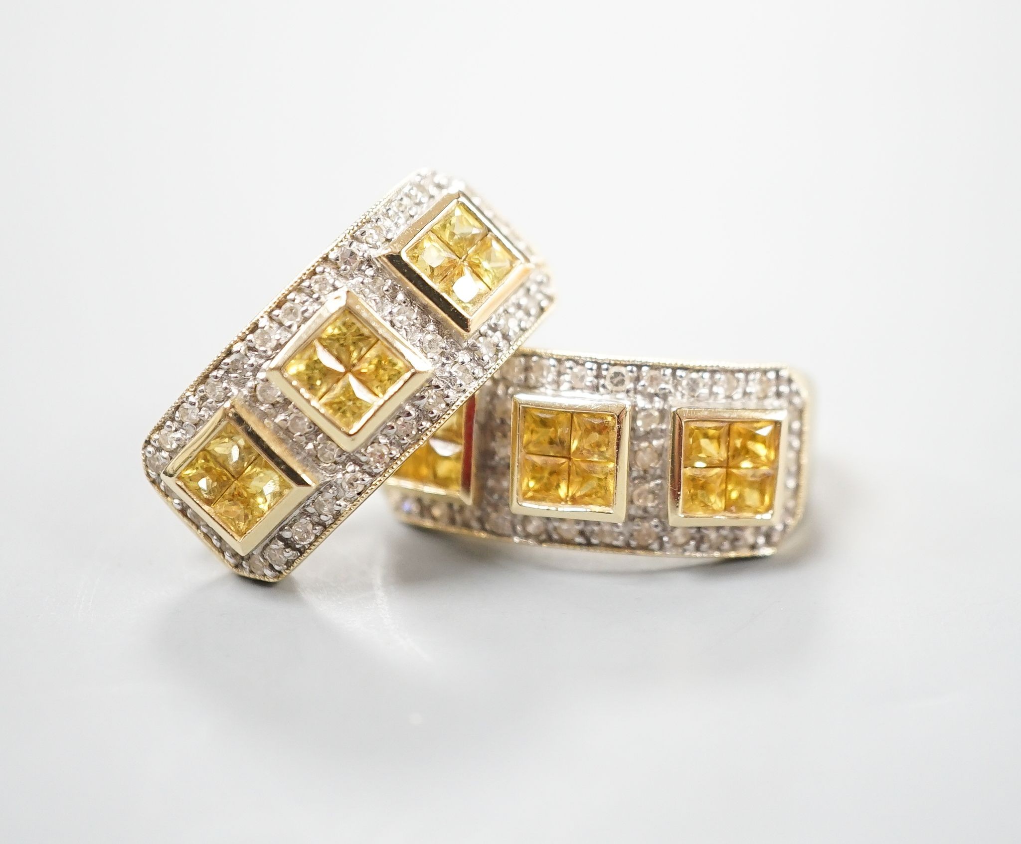 A modern pair of 14k yellow metal, diamond chip and triple cluster yellow sapphire? set half hoop earrings, 19mm, gross weight 6.9 grams.